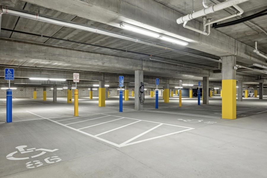 Underground parking garage with empty parking spaces, including several marked accessible spots.